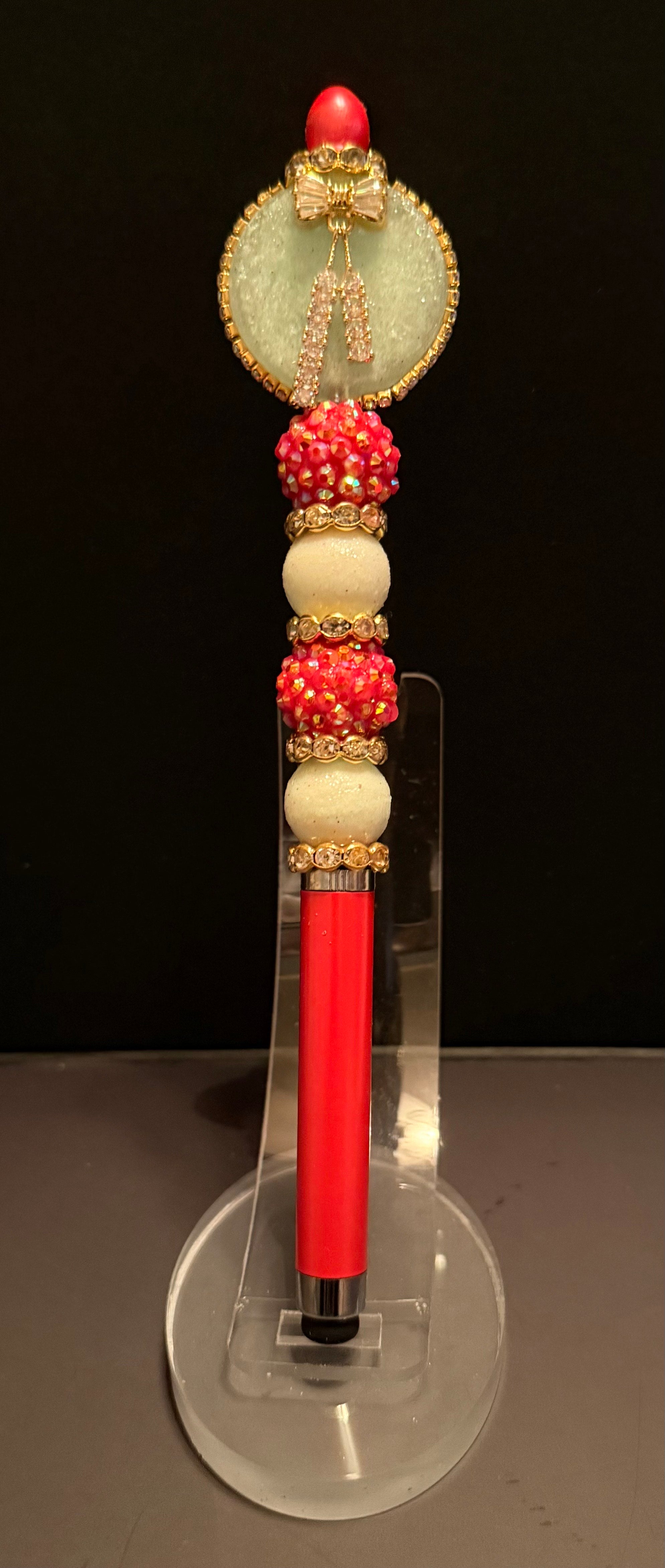 This red beaded Stylus pen glows in the dark, also has a gold bow charm